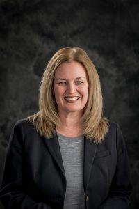 Photo of a woman facing the camera, from the waist up.